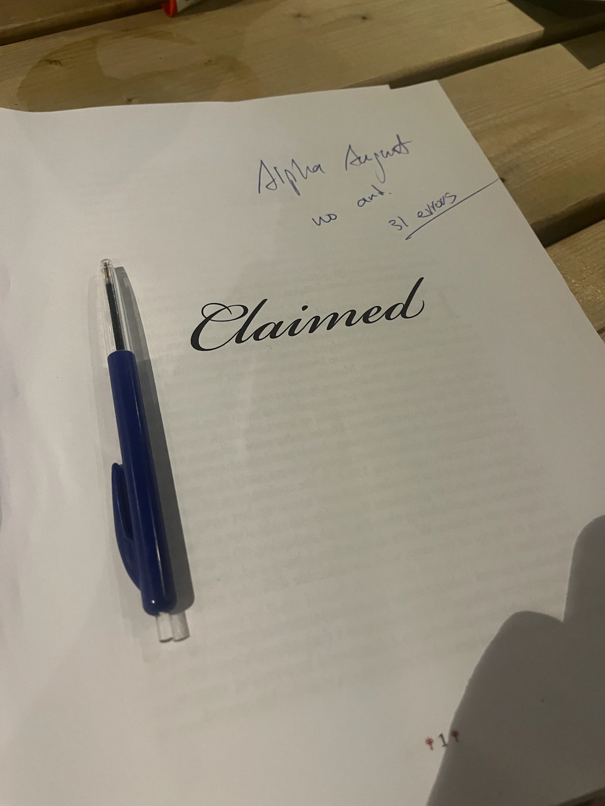 Alpha proof of the Claimed title page with a handwritten note and a pen