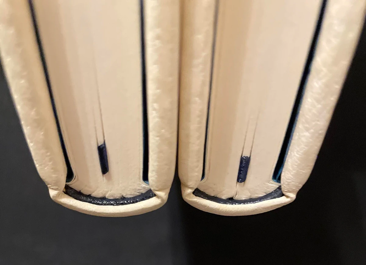 Close-up of leather endbands on two Claimed binding prototypes in cream leather