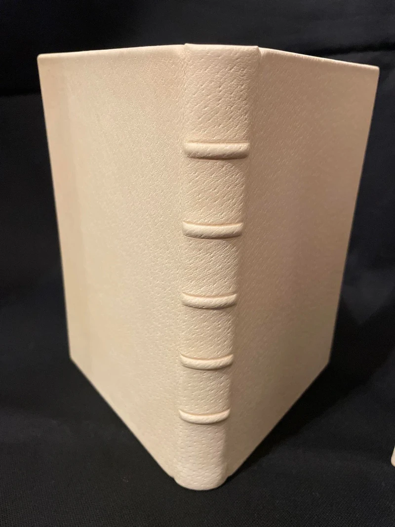 A Claimed binding prototype in cream leather, its spine with five raised bands