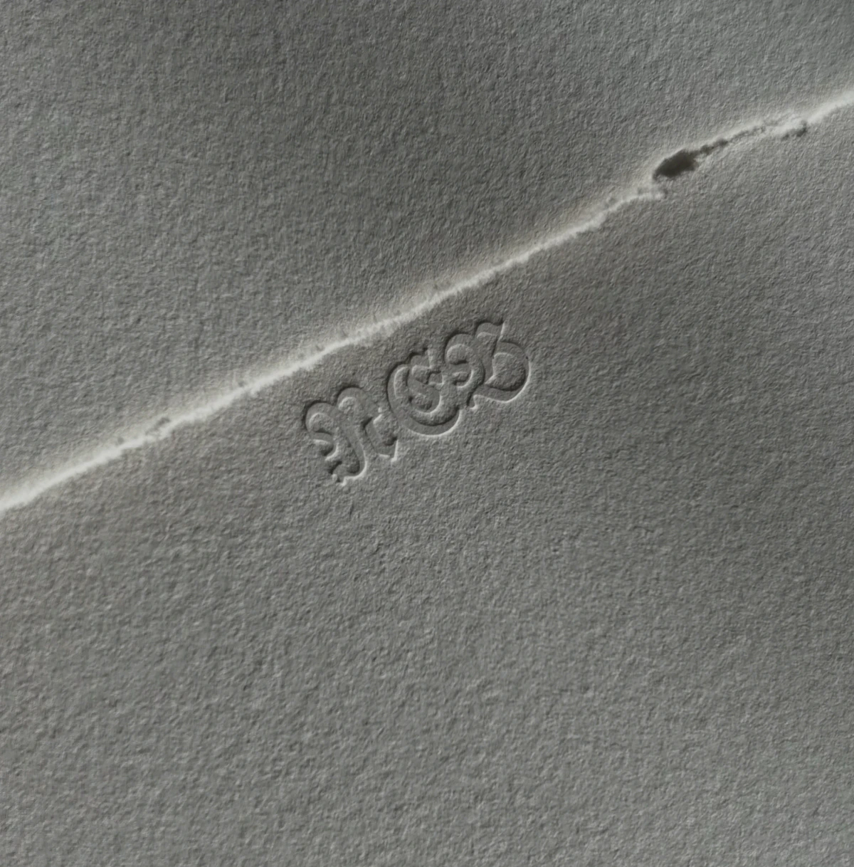 Blind stamp of Alte Fraktur capitals "N", "E" and "B"