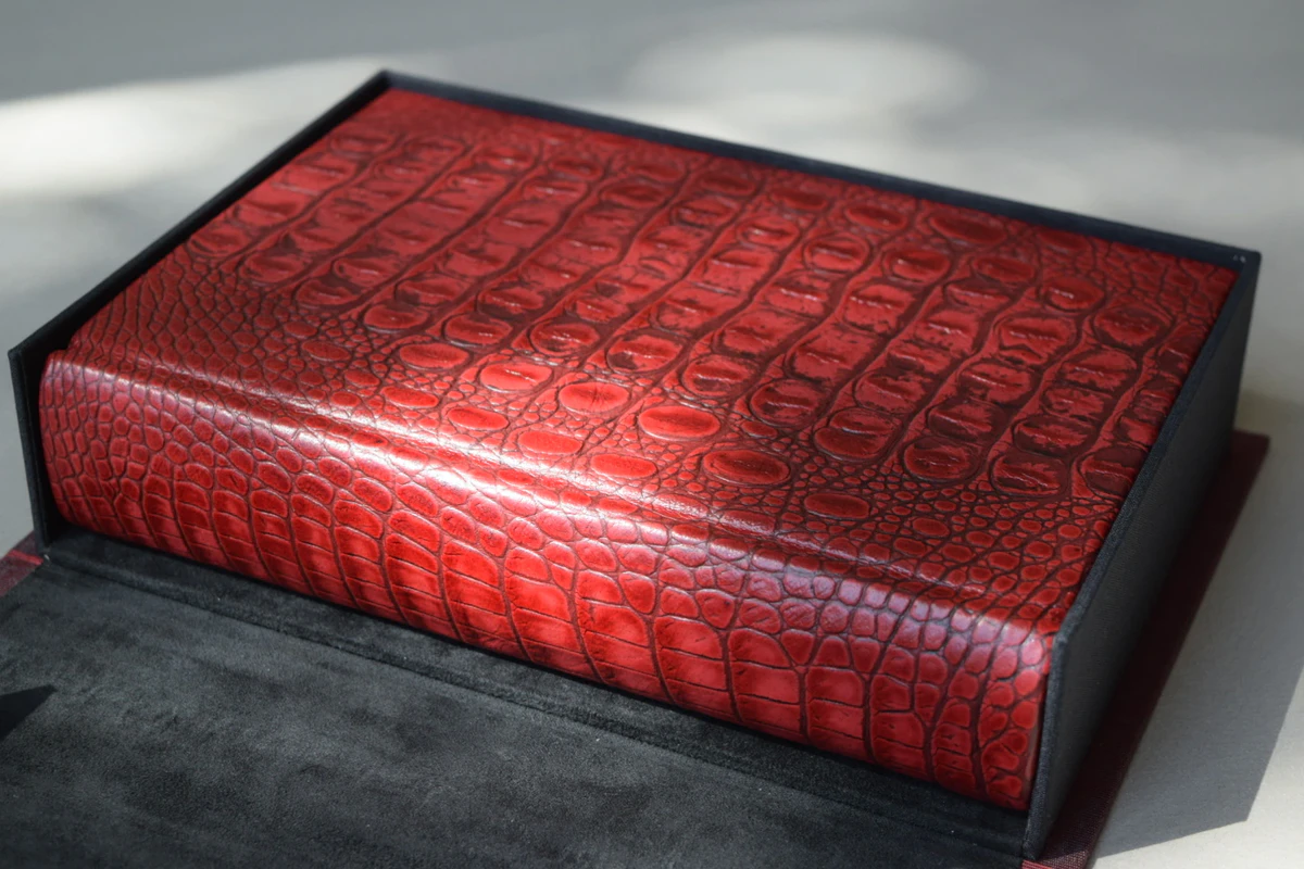 The lettered Red Dragon from Suntup Editions in its open traycase, the red hornback leather catching the sun