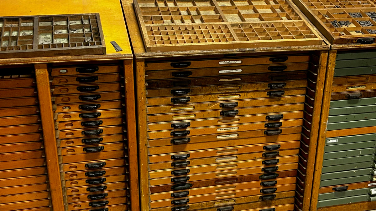 The type case at Kraaiven Press: wooden type cabinets with cases of type laid on top